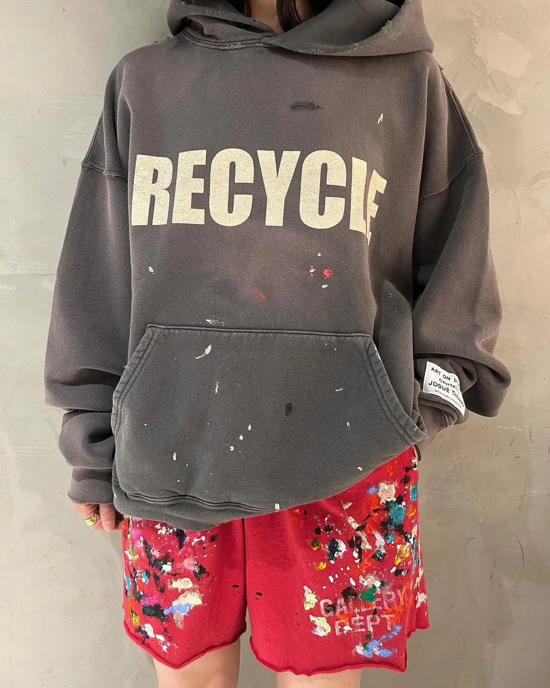 GALLERY DEPT. 90'S RECYCLE HOODIE WASHED BLACK 90'S washed hoodie with distressed eco-friendly slogans. Washed black S-XL. Ready-made garments are washed and dyed again. Multiple spots throughout the body are spray-faded. The ribs are cut and worn.